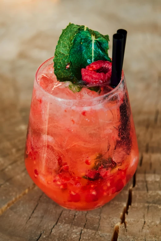 a glass with a drink inside on a table