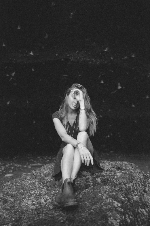 a woman in black and white is sitting in the water