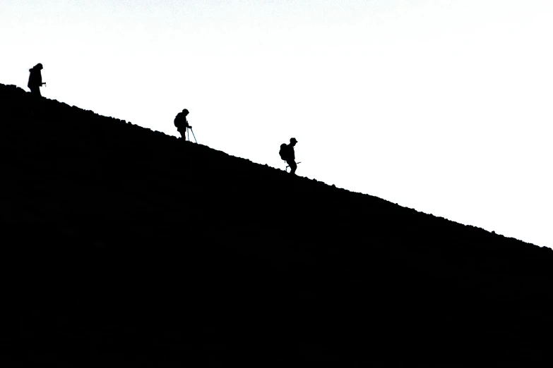 three people on top of a long hill