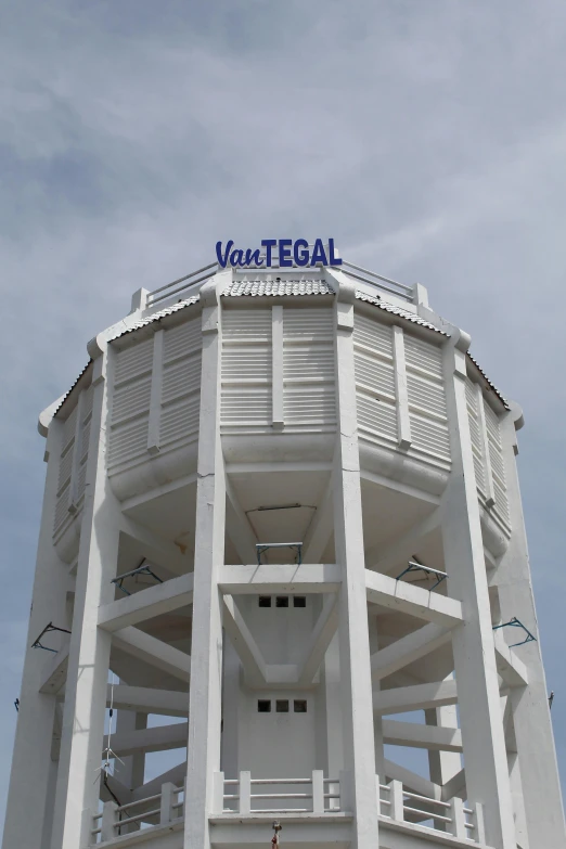 the top of a building with a blue sign above it