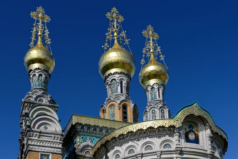 two buildings with golden top and blue sky background