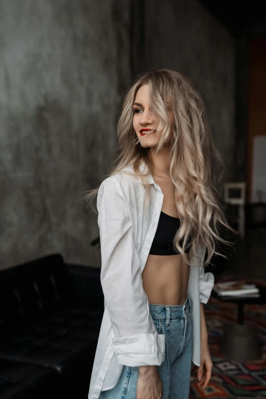 a beautiful blonde with long hair posing for a picture