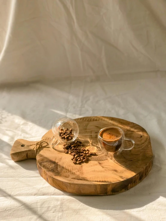 a tray with two glasses on it next to a cup