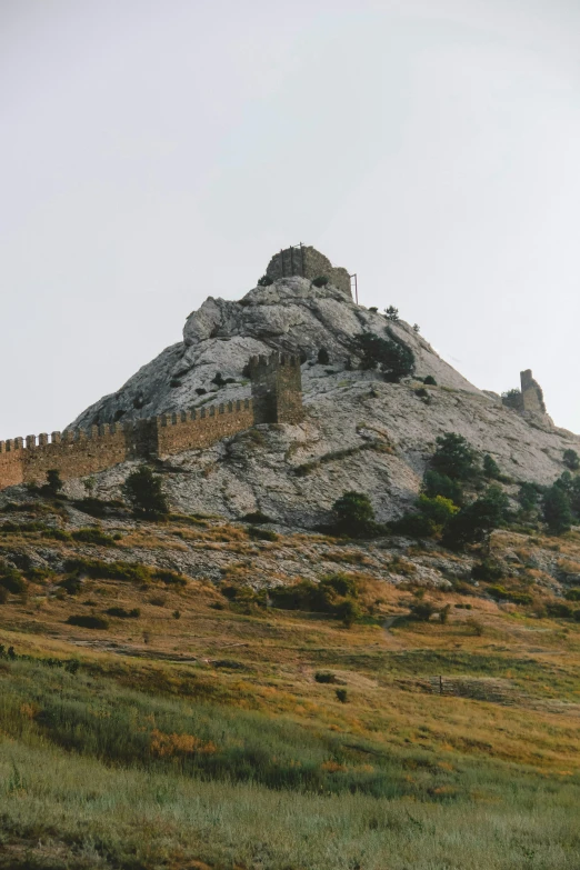 a large castle structure sitting on top of a hillside