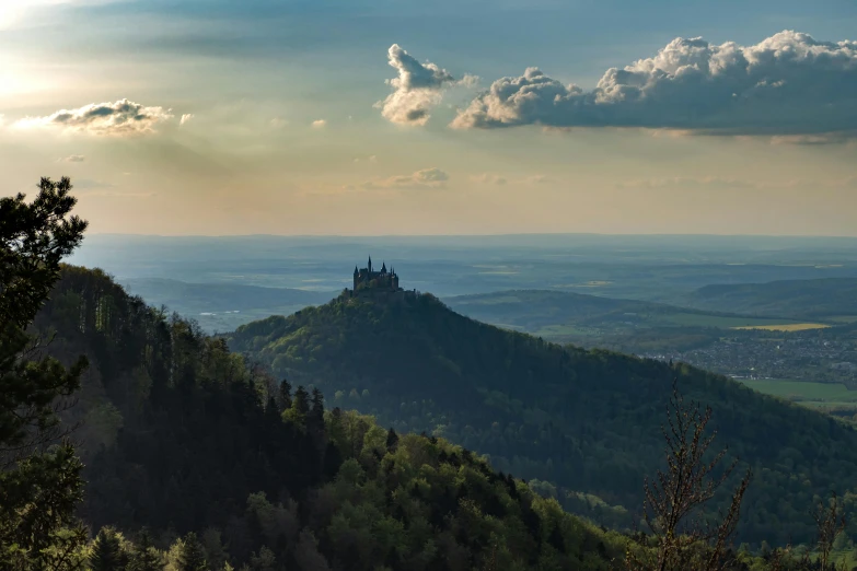 an image of the countryside behind a mountain