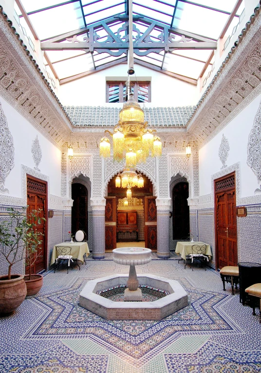 a large courtyard with decorative tiles and lighting