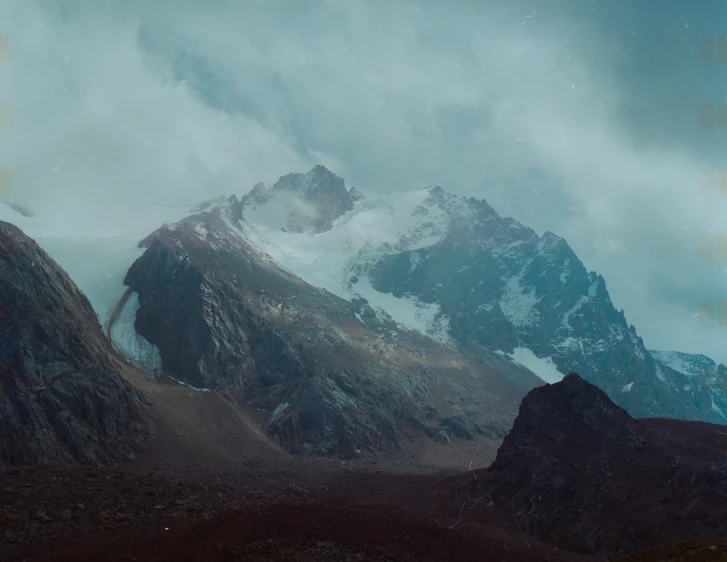 a picture of mountains and hills with a sky background