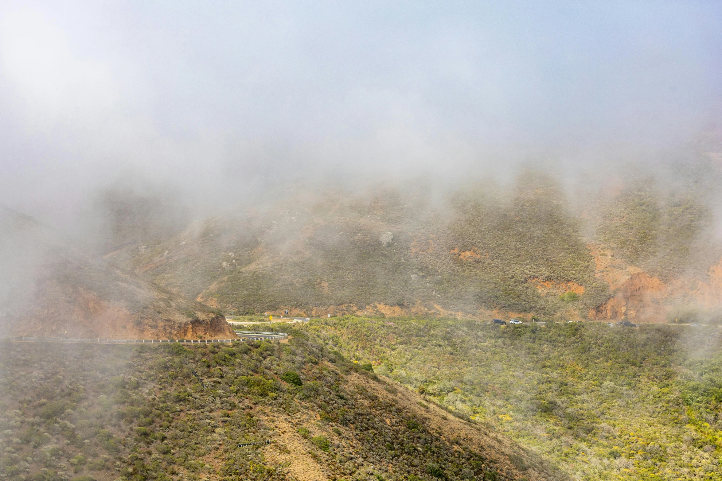 the fog rolling over the mountains on a very bright day