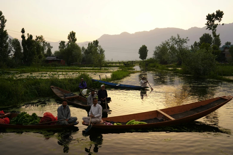people with many bags sit on a canoe