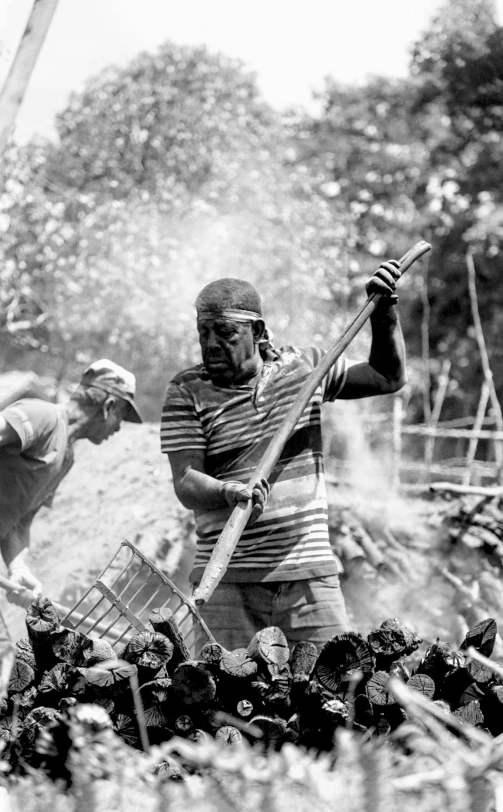 an old po shows two men in front of a bbq