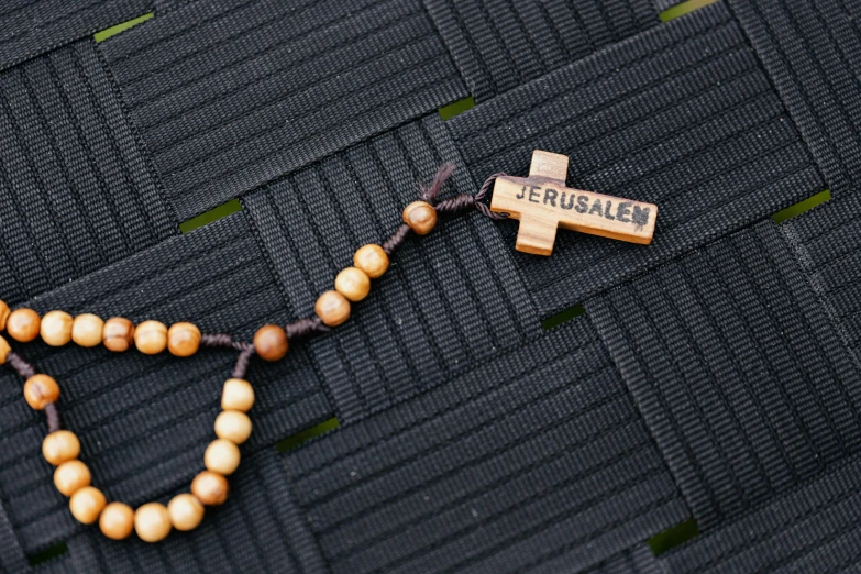 a rosary with a cross on a table