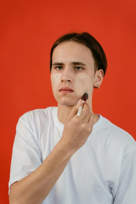 a person who is using a marker to highlight their face