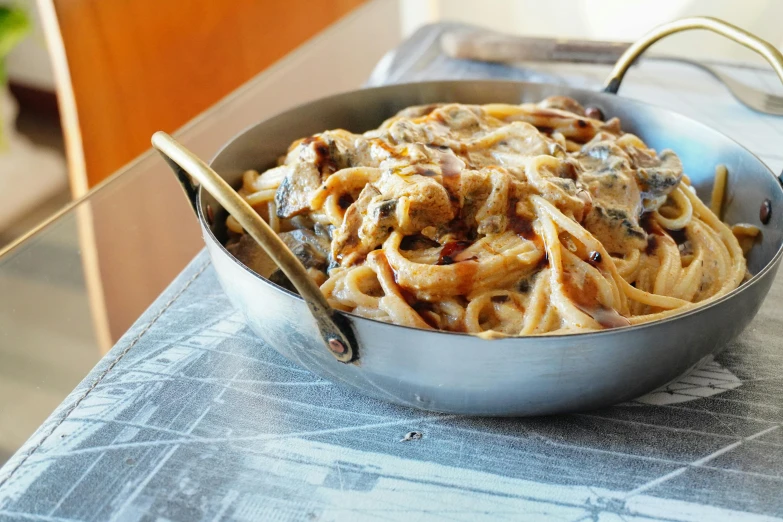 a pan of pasta with an open lid