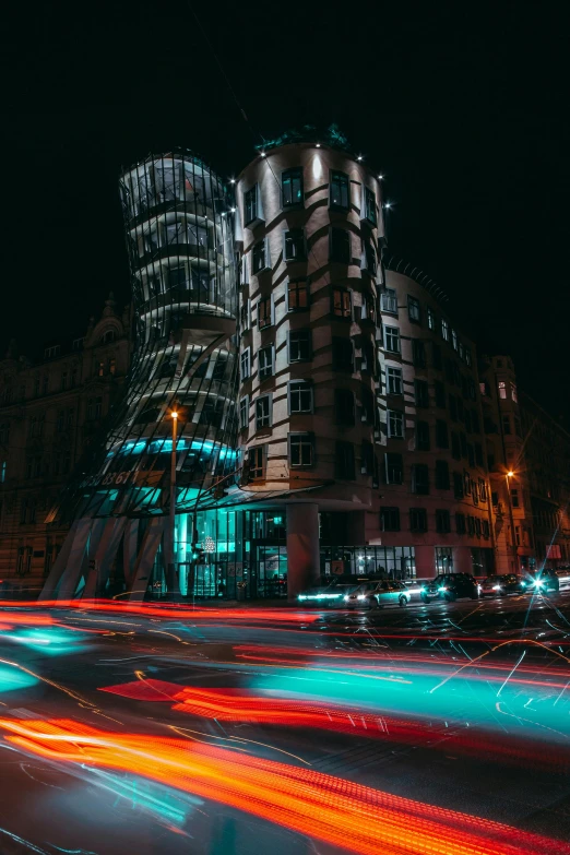 a very modern building in a city with lots of lights