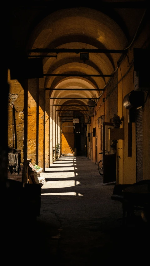 a long hallway is filled with benches and windows