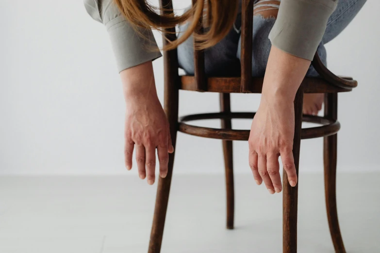 two hands sit on the back of a chair