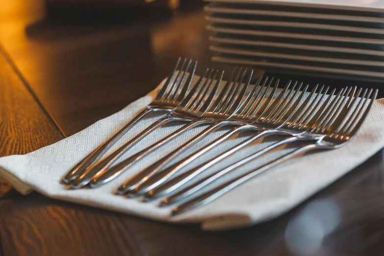 this is a table with a stack of forks sitting on it