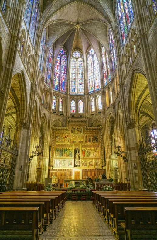 the interior of a very big cathedral with stained glass windows