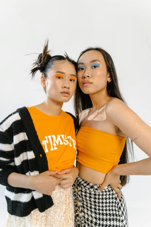 two women pose with their faces painted bright