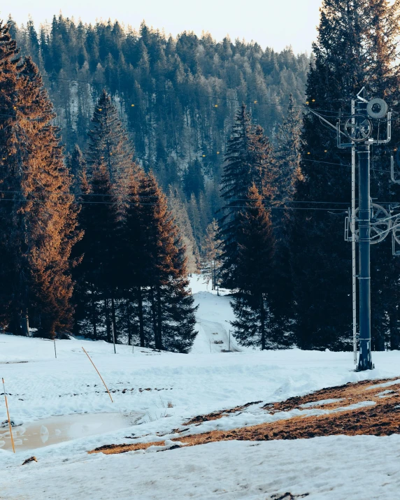 a street sign in front of a road covered in snow