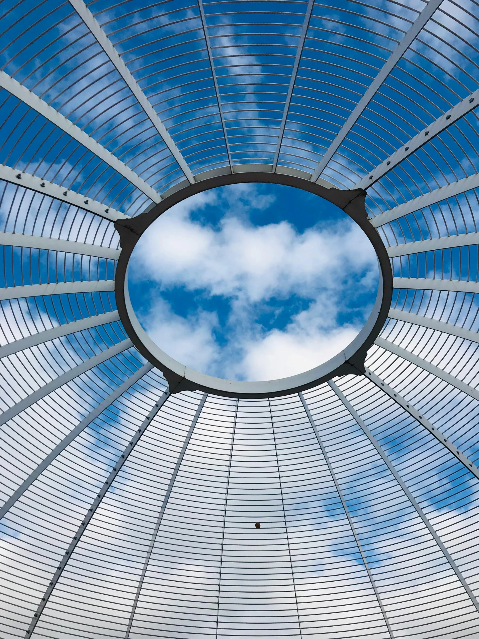 a circular window view from below looking up at the sky