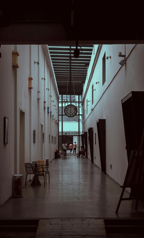 the inside of a hallway with a clock on a wall