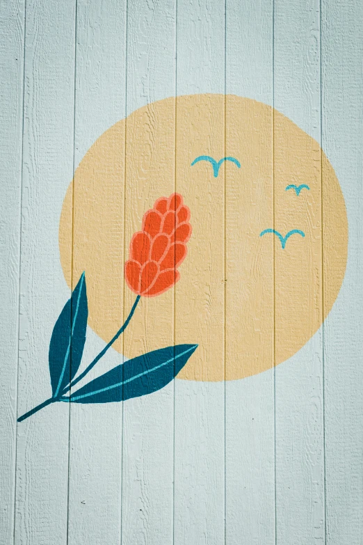 the back side of a painted wood building with a flower