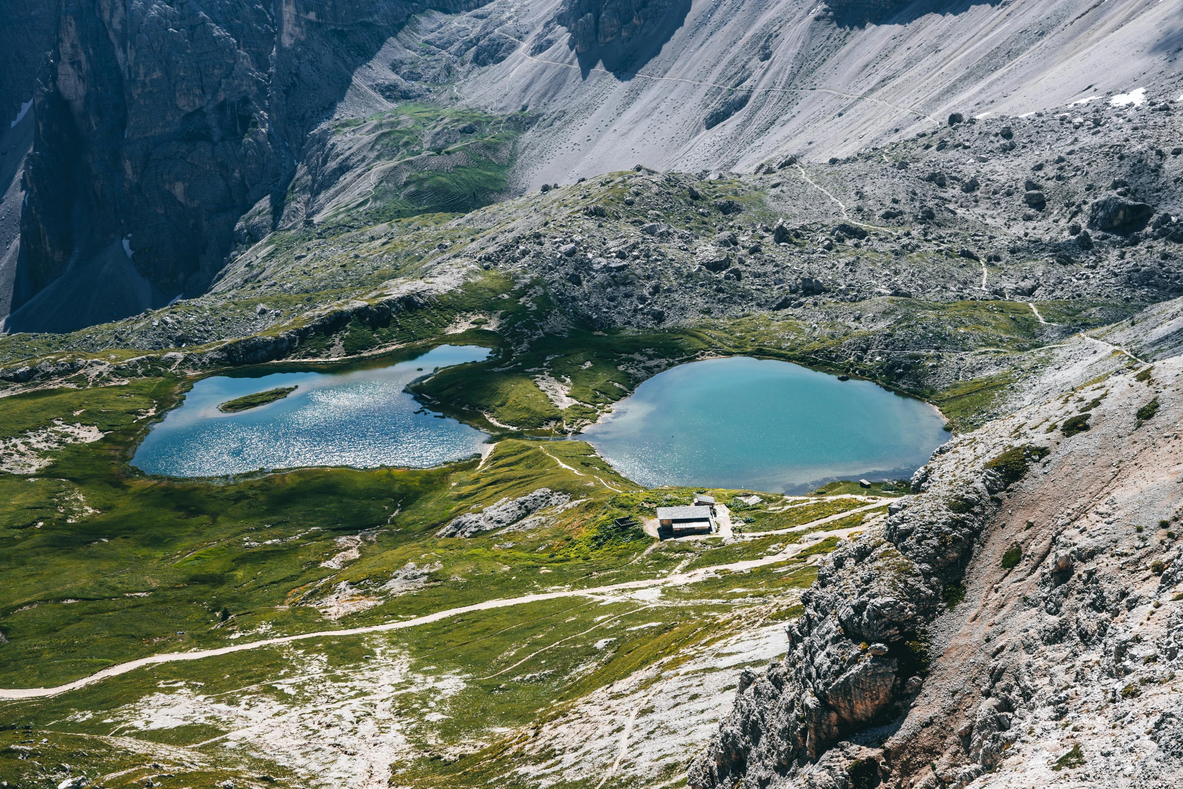 a view down on three small lakes surrounded by snow