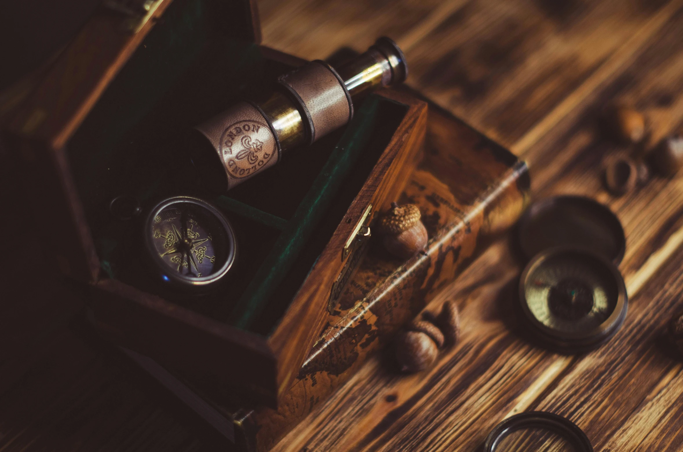 a wooden table topped with a coffee cup and a compass