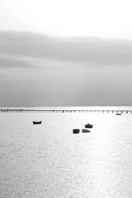 black and white po of two small boats on water