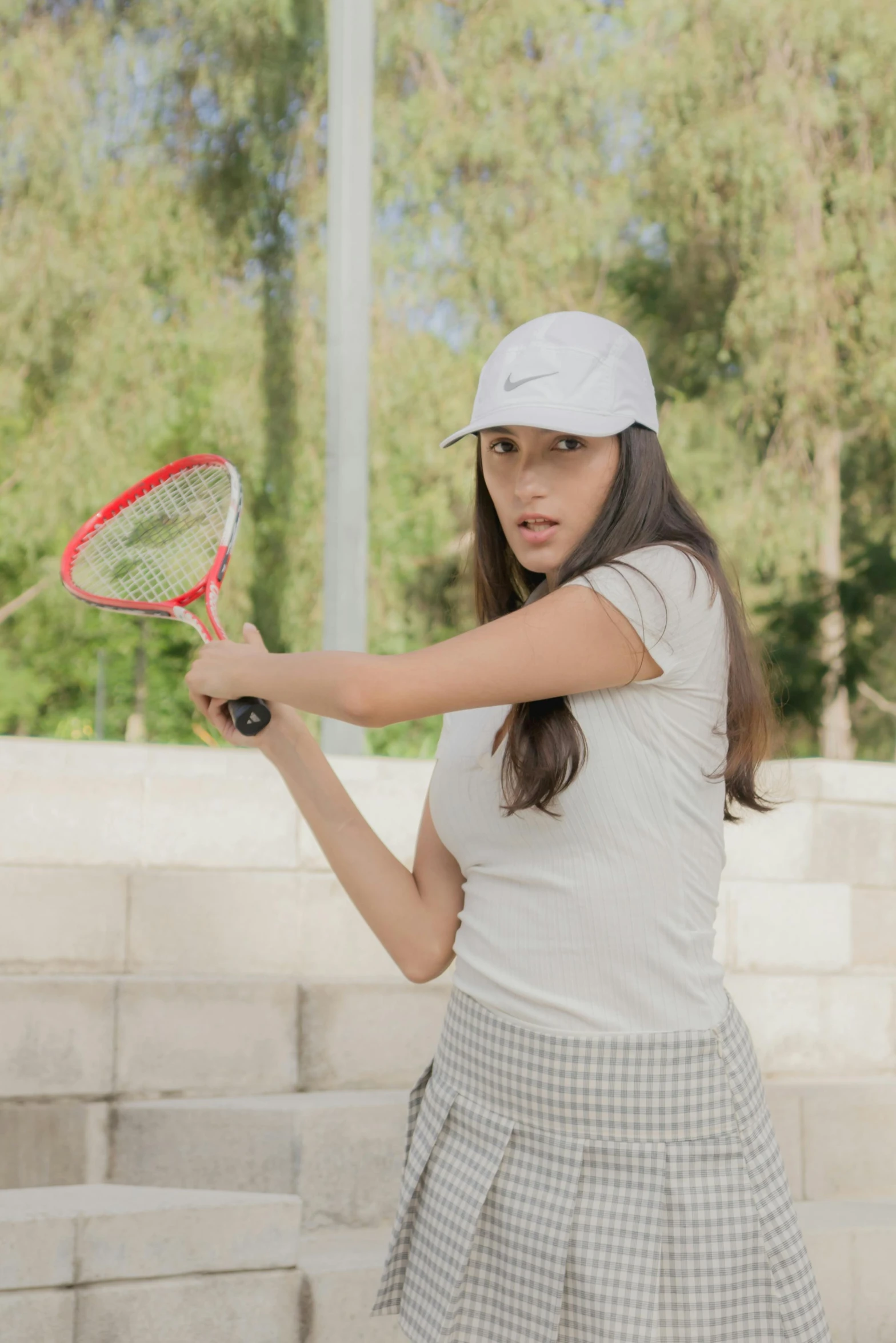 the woman in the tennis uniform holds up her racquet