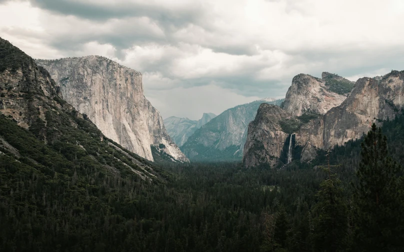 a mountain range with clouds moving in the distance