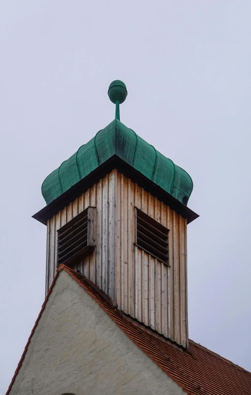 a small tower with two windows and a roof