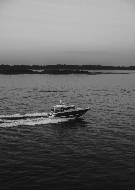 a black and white po of a boat coming in to the shore