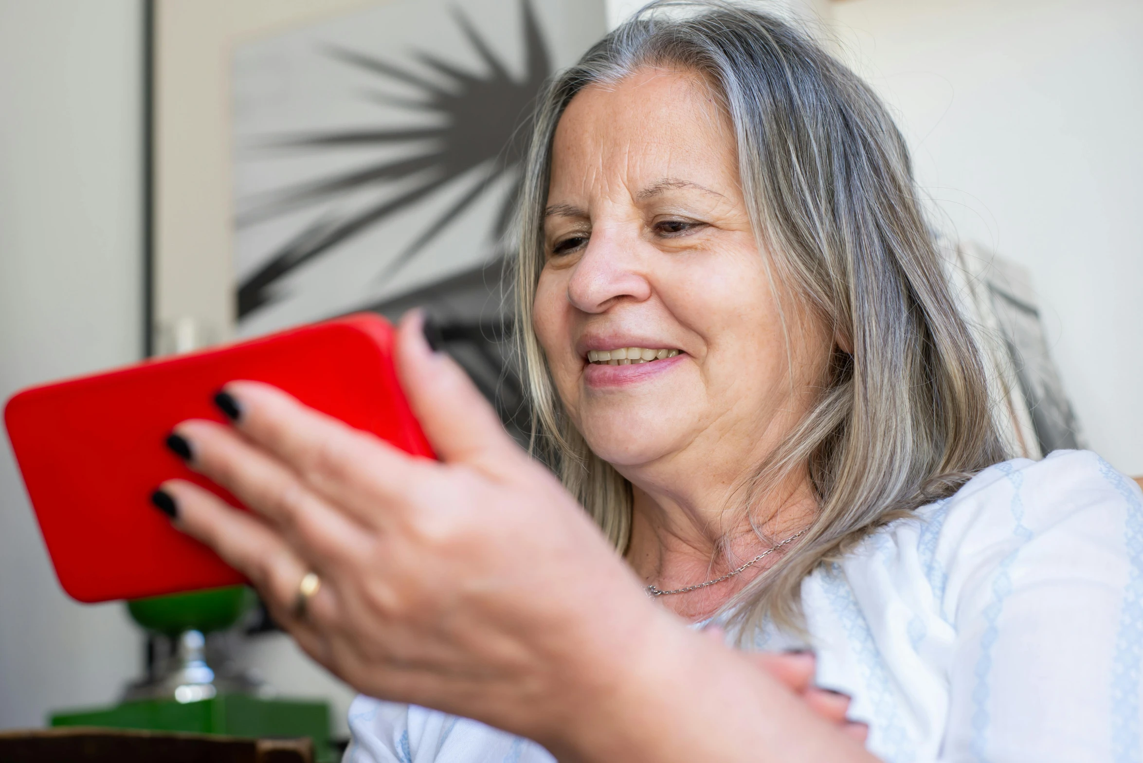 a woman is looking at her ipad with a smile