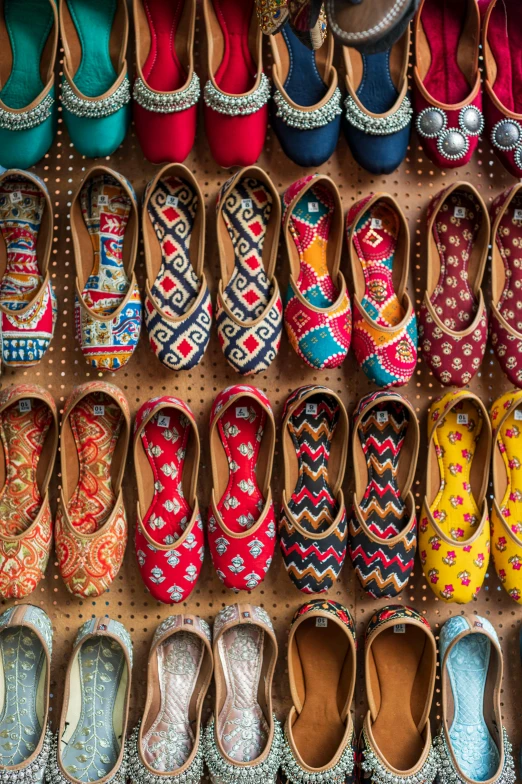 shoes are lined up together in a display case