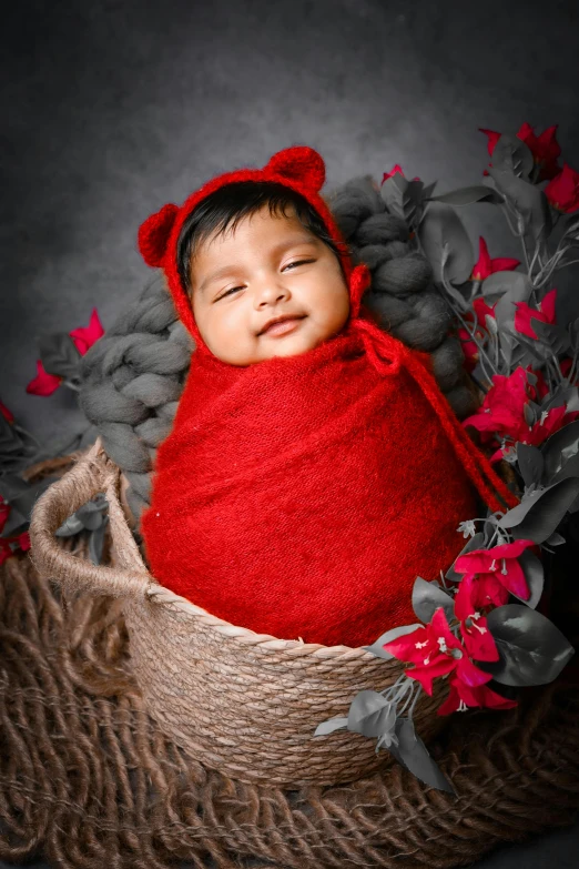 an infant with red clothing on is sleeping