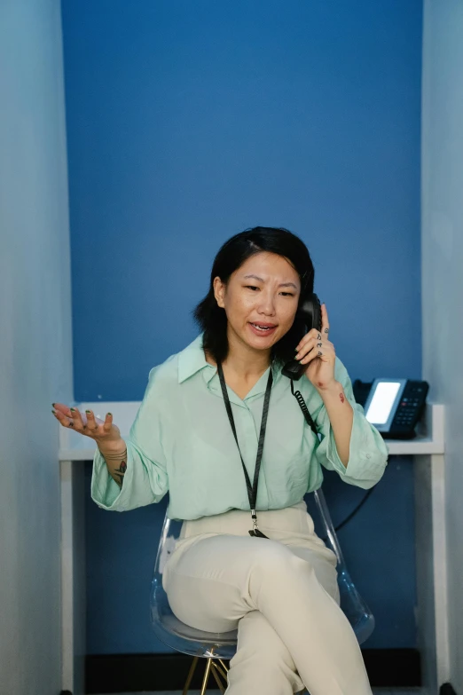 an asian woman on the phone in the room