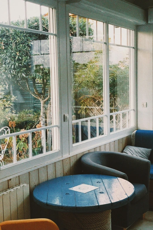 several chairs and tables are arranged on the porch of a home