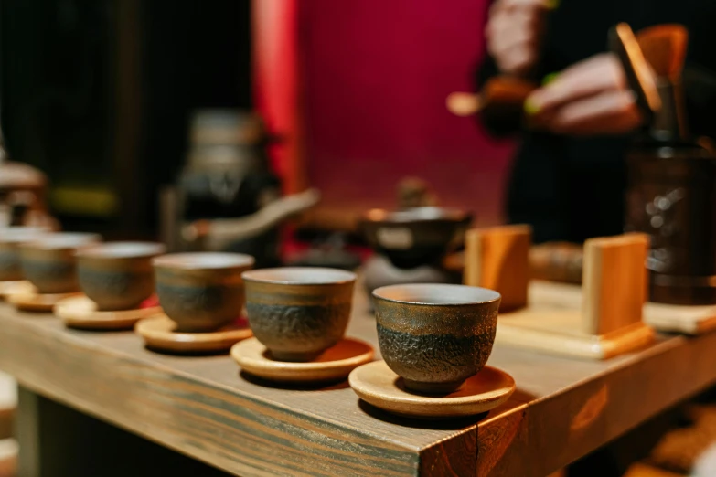 a wooden counter topped with coffee cups on top of it