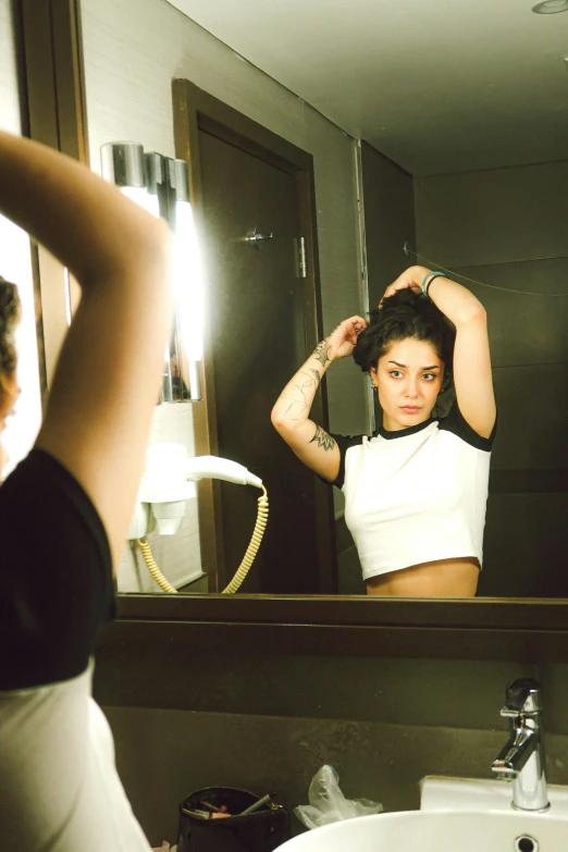 girl is drying her hair with a light mirror