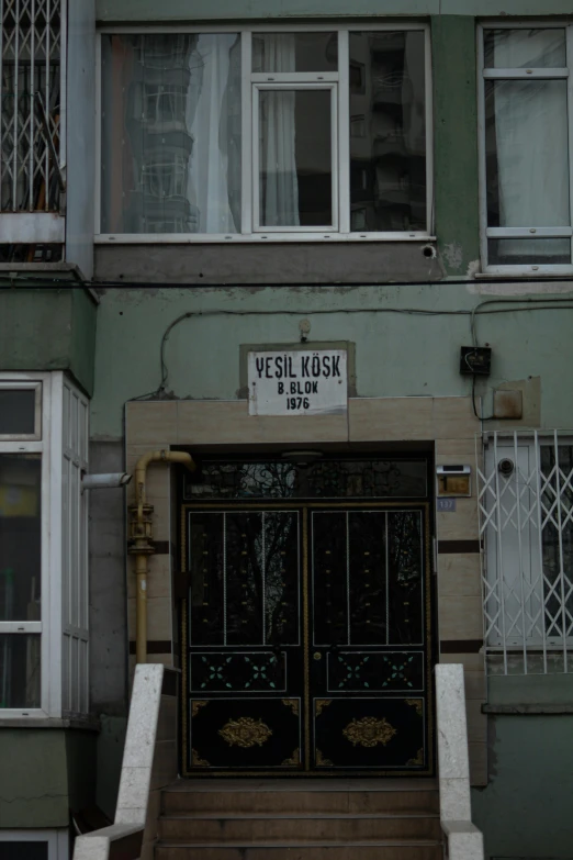 a building with a sign for versil kusk and a clock on it