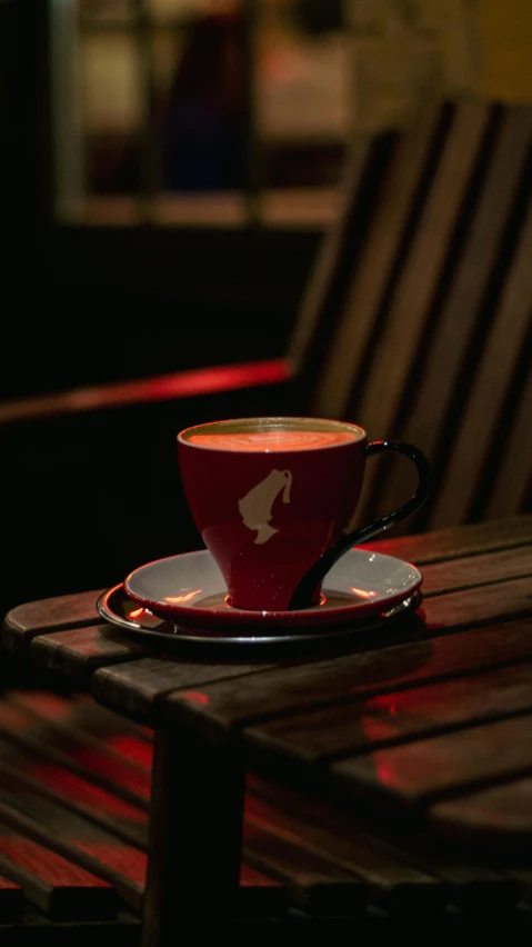 a cup with saucer sits on a table