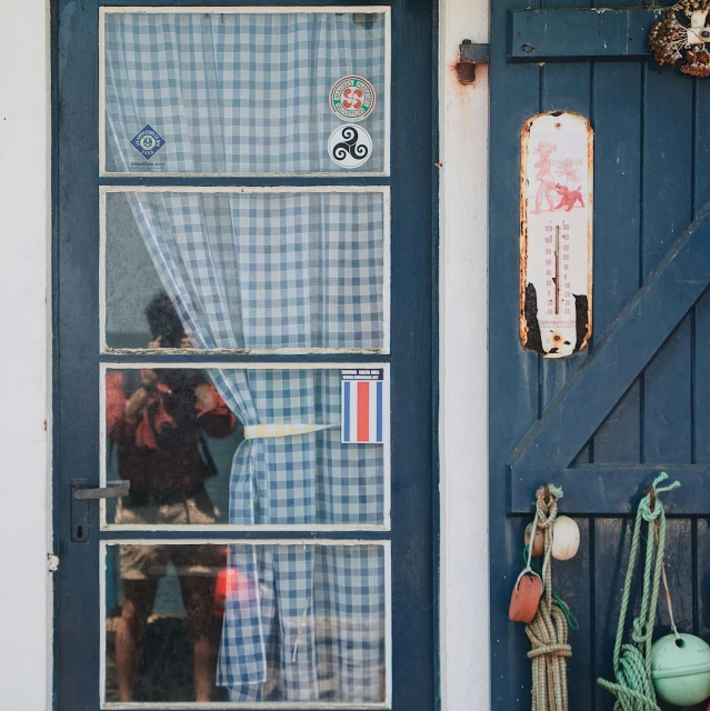 a blue and white door and some windows and pots