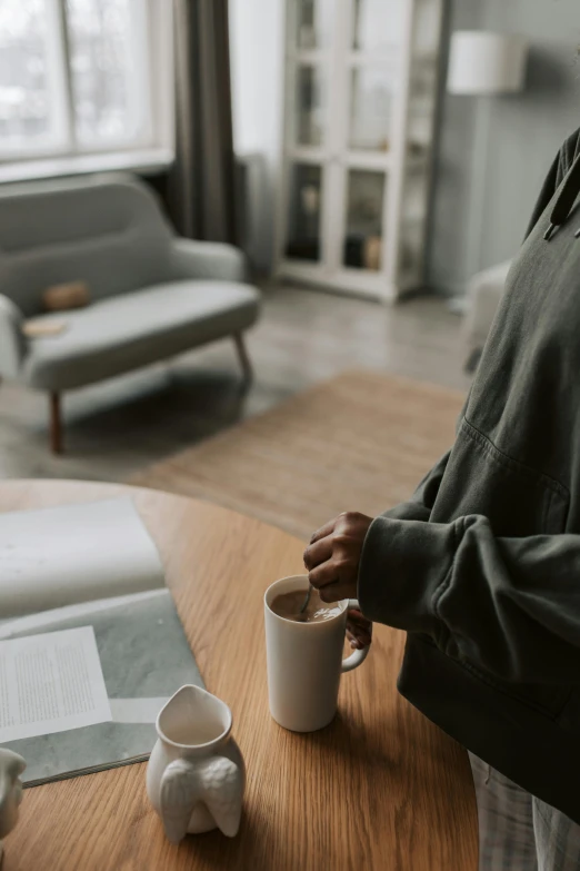 a person is having coffee with a book and book