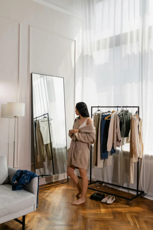 woman standing in front of a rack of clothes