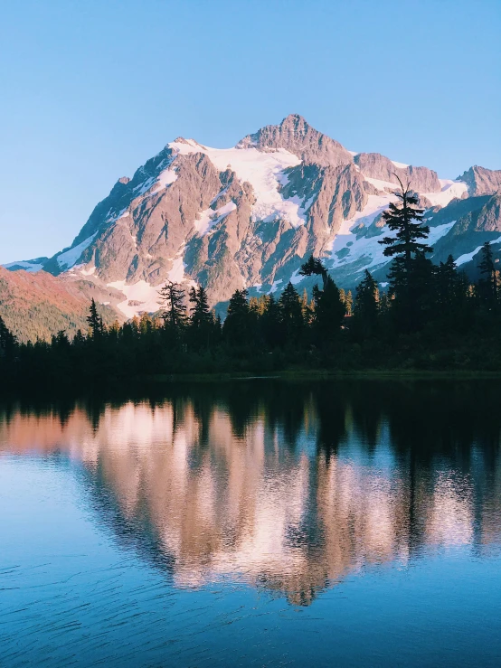 a mountain range with a snow - capped peak above it