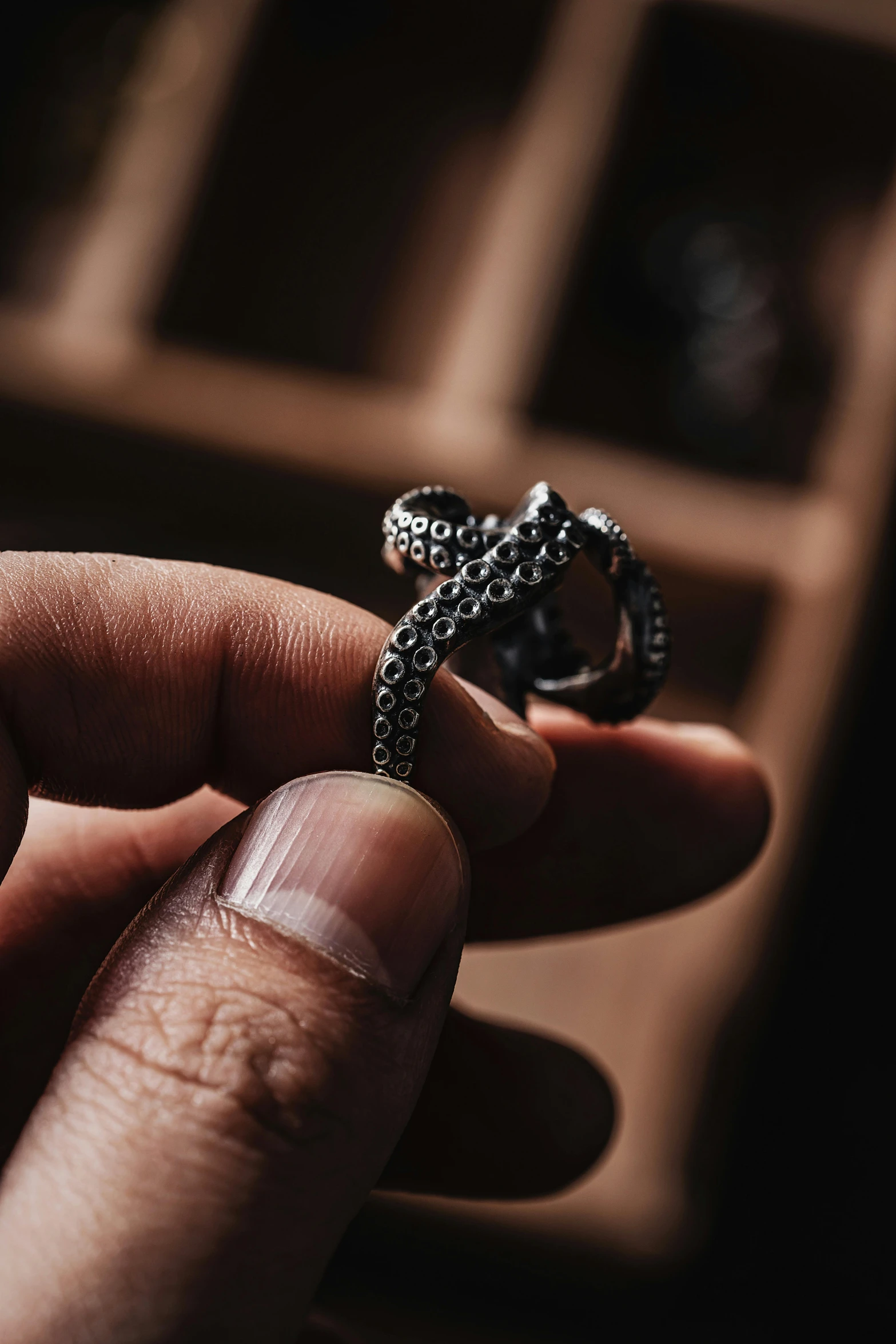 a close up of a hand holding a black diamond ring