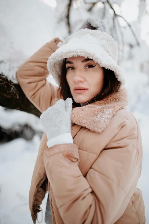a woman in winter clothes poses for the camera