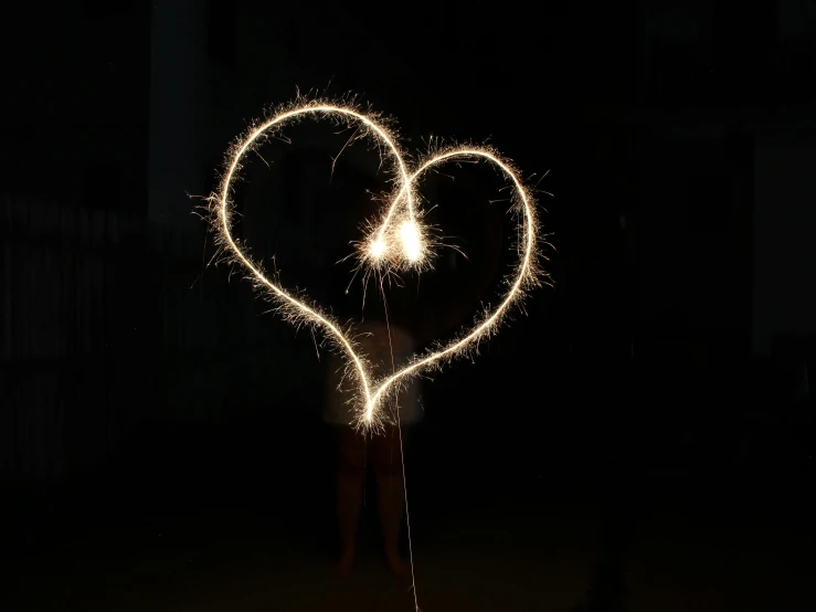 a heart shaped sparkler in the dark